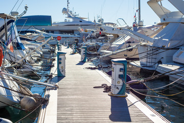 Moored yachts charching with fuel and electricity