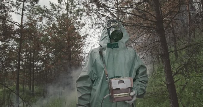 Man in WWII Hazmat suit and mask doing tests