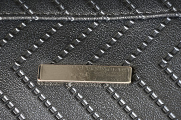 Fototapeta premium Texture of black artificial leather with embossed arrows