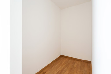 Empty white room with white walls and light parquet
