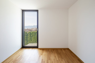 Fototapeta premium Empty white room with light parquet and window overlooking Lake Maggiore