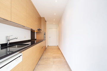 Light wood kitchen with dishwasher, stove and oven