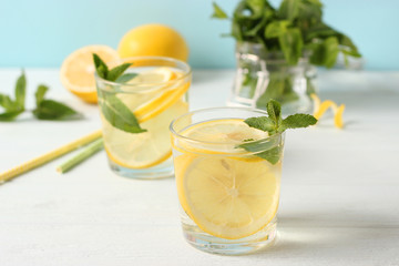 water with lemon on a colored background