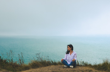 young casual woman travel  in white t shirt and jeans   posing near sea