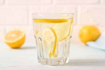 water with lemon on a light background