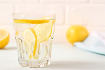 water with lemon on a light background