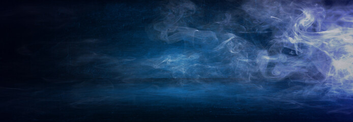 Fototapeta na wymiar dark blue cement wall studio background with mist or fog, colorful smoke backdrop