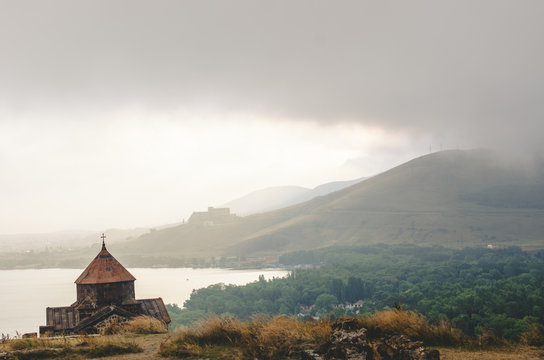 Old Sevanavanq monastery while rainy weather in Sevan Armenia