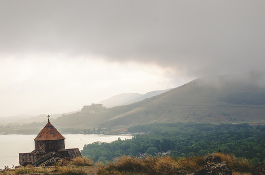 Old Sevanavanq monastery while rainy weather in Sevan Armenia