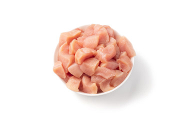 Raw chicken fillet chunks isolated on white