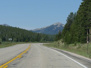 Wide scenic view of nature along Highway 16 through Bighorn National Forest mountain ranges in Wyoming.