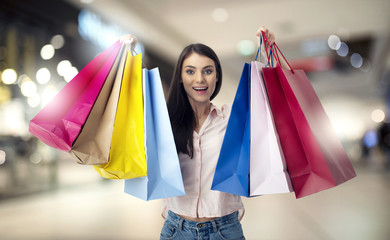 Happy woman with shopping bags in hand