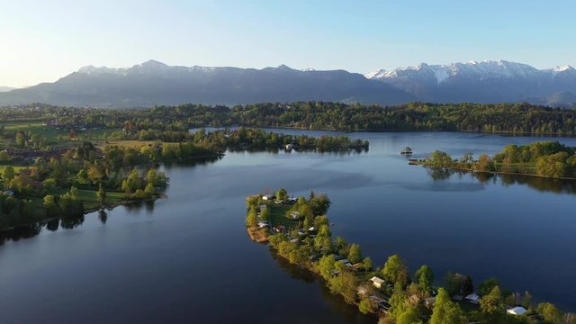 Flight over the campig island of Buchau in lake Staffelsee in Bavaria, Germany