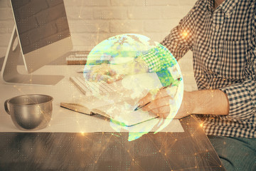 Social network theme hologram with businessman working on computer on background. Concept of world...