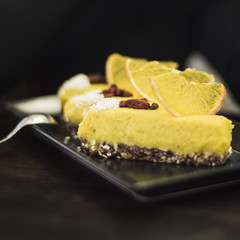 Lemon cake slice on tray against black backdrop