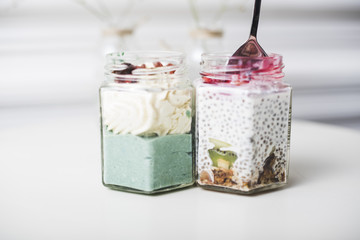 Fruit smoothies in the glass jar on white table