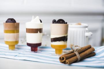 Bundle of cinnamon sticks with chocolate mousse in glasses