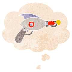 cartoon ray gun and thought bubble in retro textured style