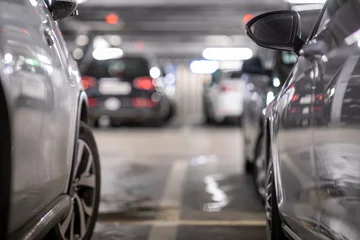 Foto op Plexiglas Underground garage or modern car parking with lots of vehicles, perspective © lightpoet