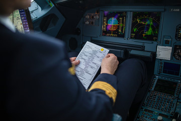 Pilot's hand accelerating on the throttle in  a commercial airliner airplane flight cockpit during...