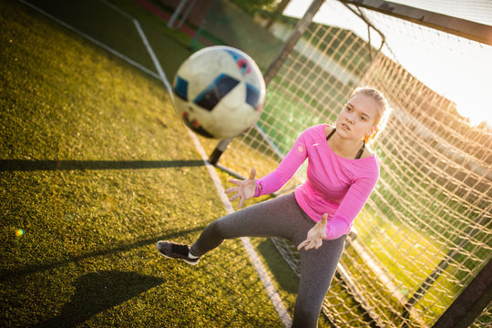 Teen Female Goalie Catching A Shot During A Soccer Game