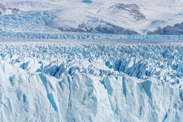Close up view of shining white blue huge glacier freeze ice in sunny day at Perito Moreno glacier...