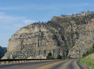 Fototapeta na wymiar Breathtaking view of imposing geologic formations and rock walls along the road cutting through the Bighorn Mountains in Wyoming.