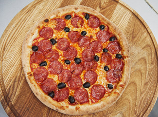 Top view. Picture of prepared delicious pizza with sausage rings and olives