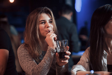 Drinking alcohol. Happy people have conversation in the luxury night club together