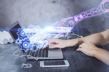 Businessman with computer background with technology theme hologram. Concept of hightech. Multi exposure.