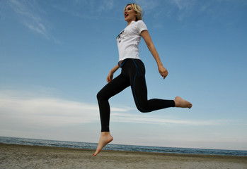 beautiful girl jumping on the beach