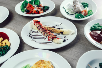 tubes with cream filling and other dishes on the table