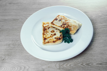 close up. pancakes with meat filling and a sprig of parsley