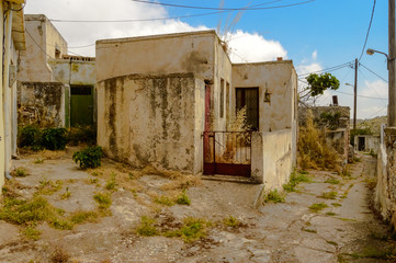 Fototapeta na wymiar Old abandoned town. Narrow street in old Greek village. Traditional buildings.