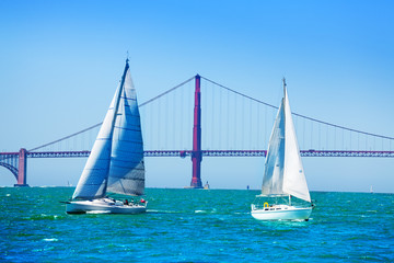 White sailboats against Golden Gate Bridge, USA