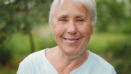 Closeup portrait of an old woman on nature