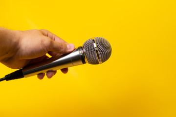 hand with microphone isolated on white background