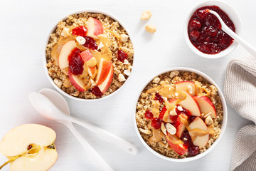 apple peanut butter quinoa bowl with jam and cashew for healthy breakfast