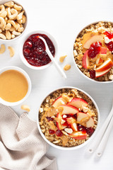 apple peanut butter quinoa bowl with jam and cashew for healthy breakfast