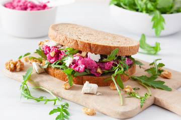 beetroot and feta cheese sandwich with walnuts and rocket