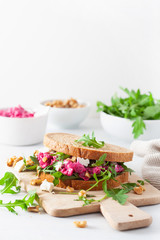 beetroot and feta cheese sandwich with walnuts and rocket