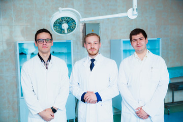 Medical students profession staff. multinational people - doctor, nurse and surgeon. A group of graduates of a medical university in a surgical room.