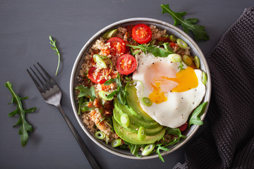 quinoa bowl with fried egg, avocado, tomato, rocket. Healthy vegetarian lunch