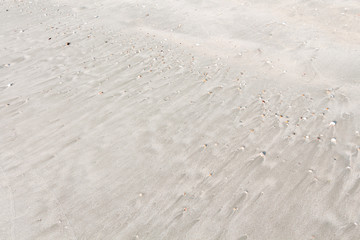 Sand texture top view on the tropical beach with visible sand texture for background with copy space for text.
