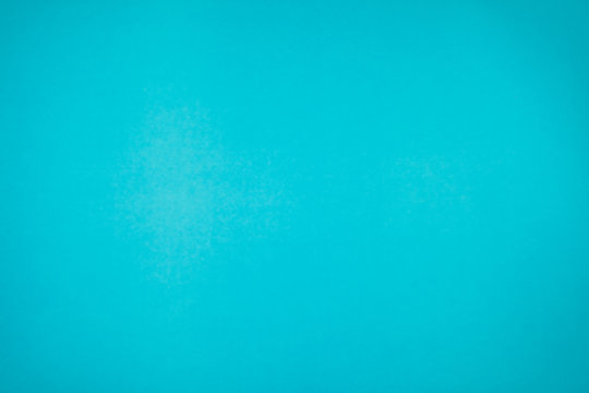 A little mottled bright blue turquoise paper plain and solid for minimal object background.