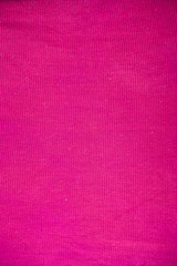 Fototapeta premium Close up of a pink colored vertical shot of the fabric texture with some minimal square pattern on it.