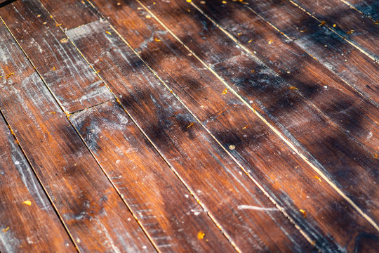 Damaged Outdoor Wood Plate Arrange And Transform To The Floor With The Shadow Of Tree.