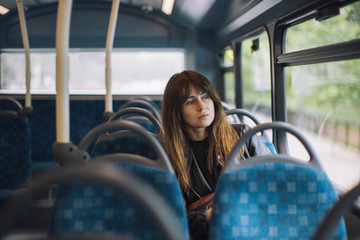 A portrait of a young woman in the bus.