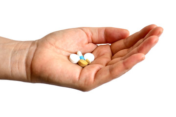 Female hand with pills isolated on white background, time to take medicine.