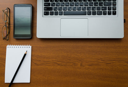 laptop keyboard with notebook pencil